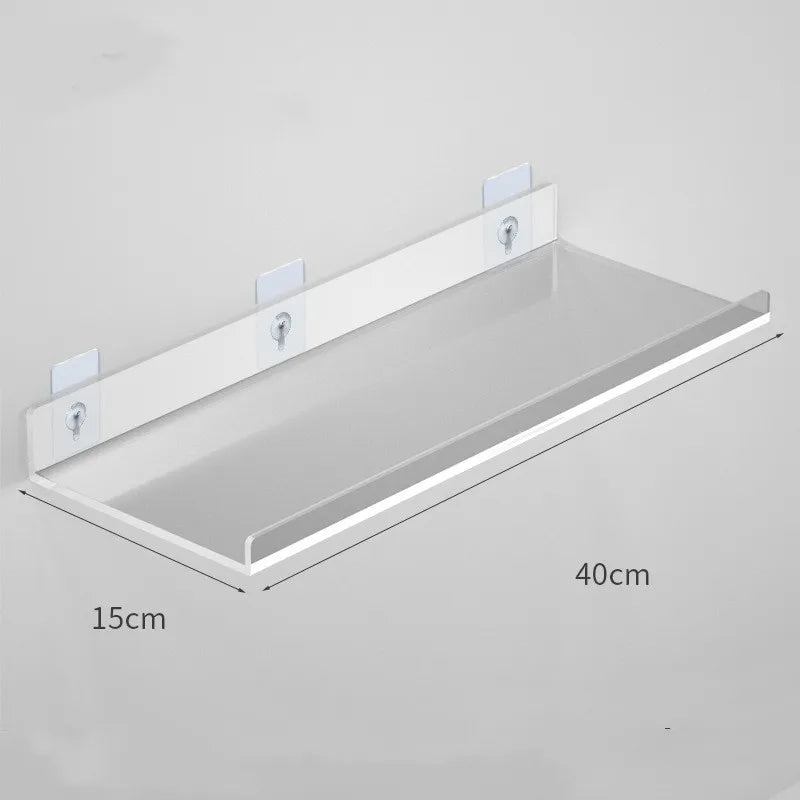 Clear acrylic floating shelf with wall mounts shown from above.