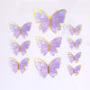 A collection of purple and gold butterfly cake toppers for parties and baking.