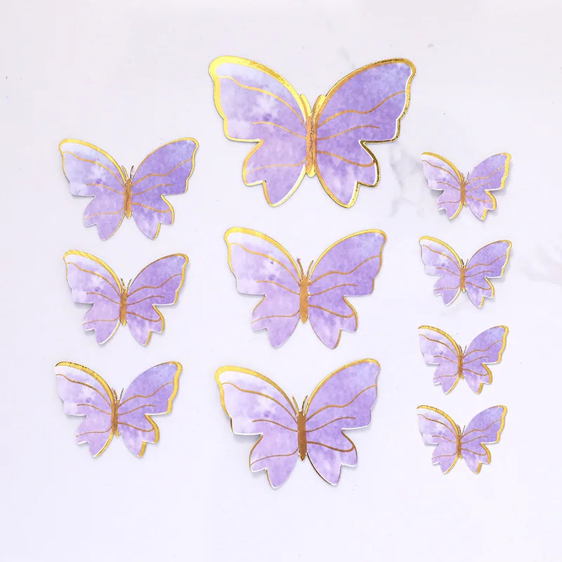 A collection of purple and gold butterfly cake toppers for parties and baking.