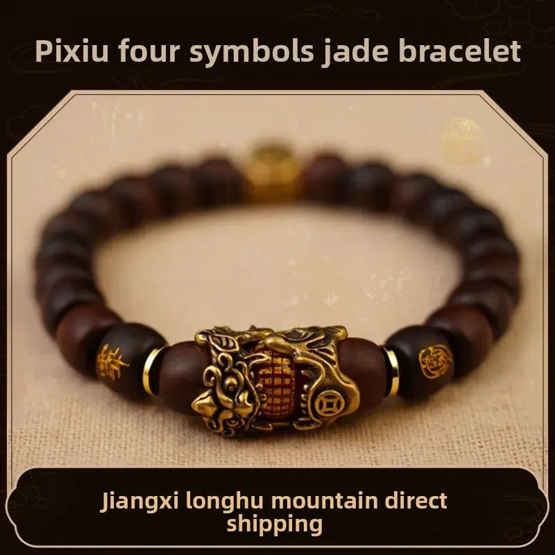 A dark brown bracelet featuring four jade symbols and an ornate gold-colored centerpiece.