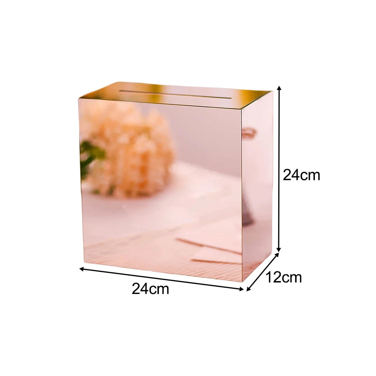 A rectangular pink acrylic gift box with a gold rim and a textured orange-colored object inside.