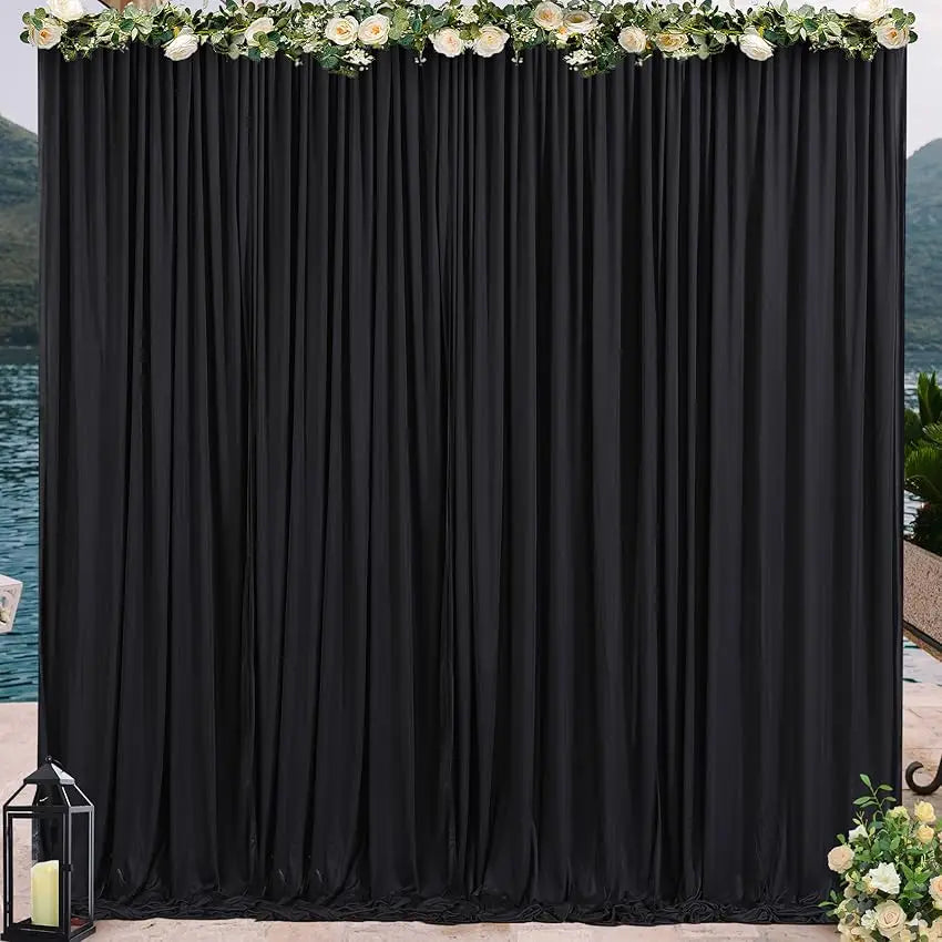 Elegant rectangular black drape backdrop with white floral garland for events
