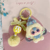 A cute heart plush keychain charm featuring a yellow flower and a small, round, fluffy yellow pom-pom.