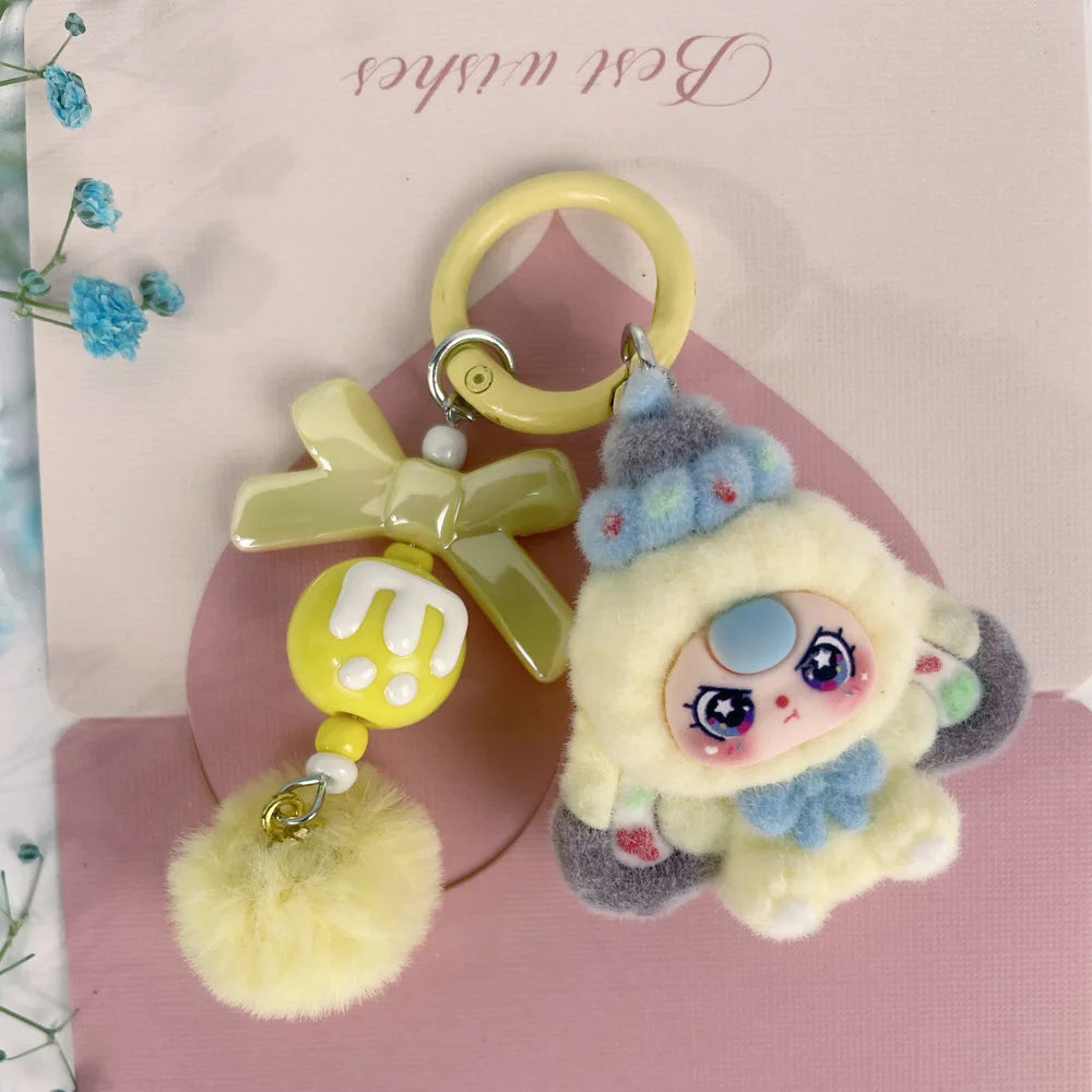 A cute heart plush keychain charm featuring a yellow flower and a small, round, fluffy yellow pom-pom.
