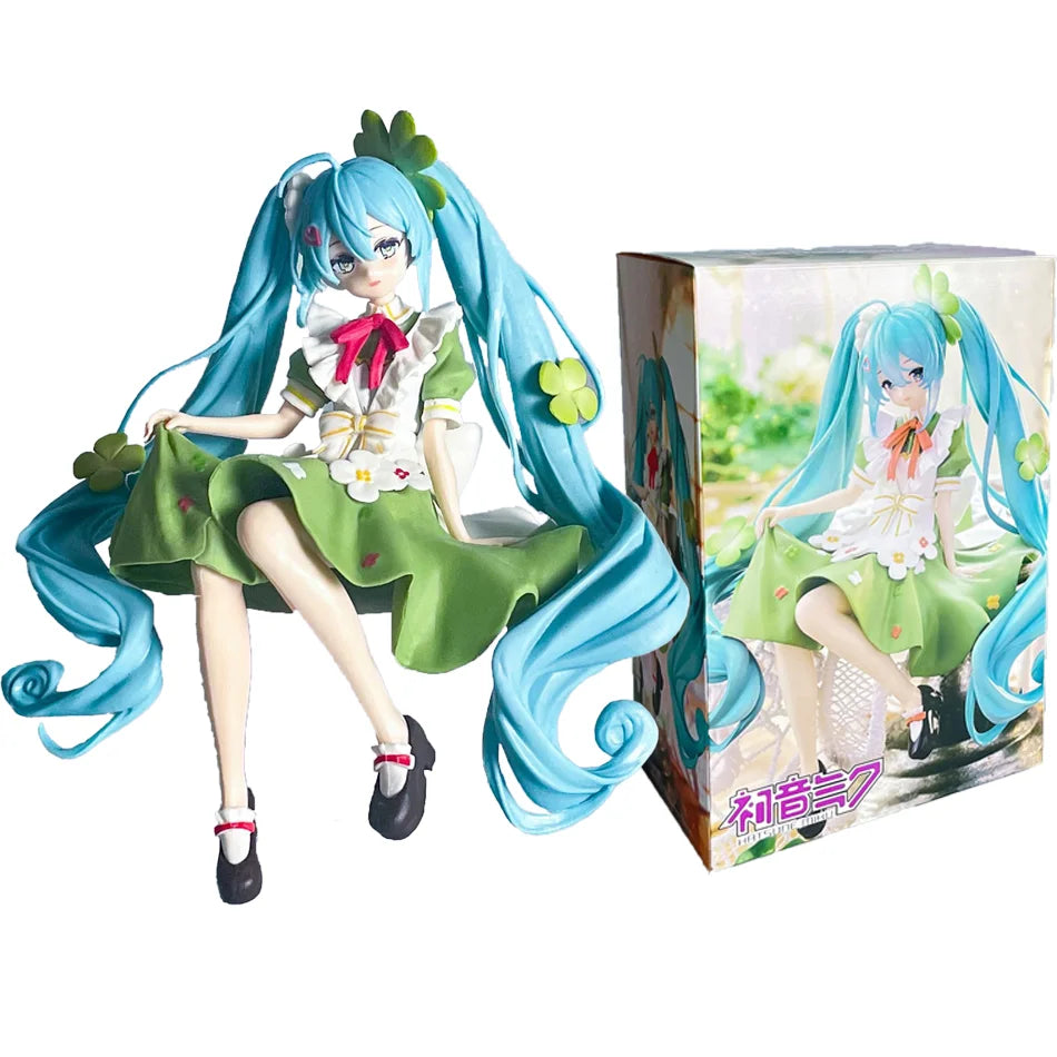 A PVC collectible figurine of Hatsune Miku in a green dress with blue hair and accessories.