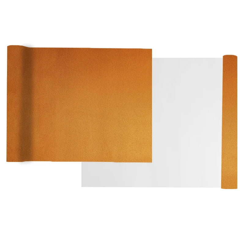 A sheet of orange suede wrap fabric is shown next to a white piece of material.