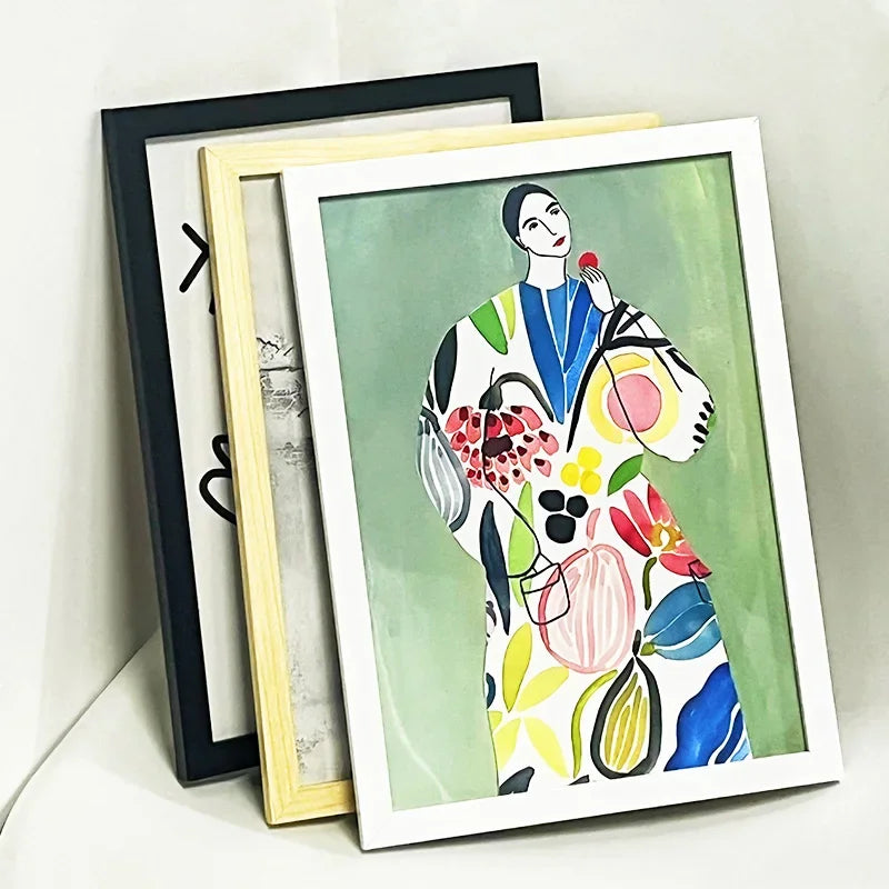 Three picture frames displaying a colorful floral painting in various wood and acrylic frames.
