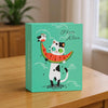 A teal box featuring a cartoon cat holding a watermelon slice, designed as a photo album cover.