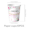 Paper cups with a sweet baby theme featuring pink flowers and a baby outfit for a shower