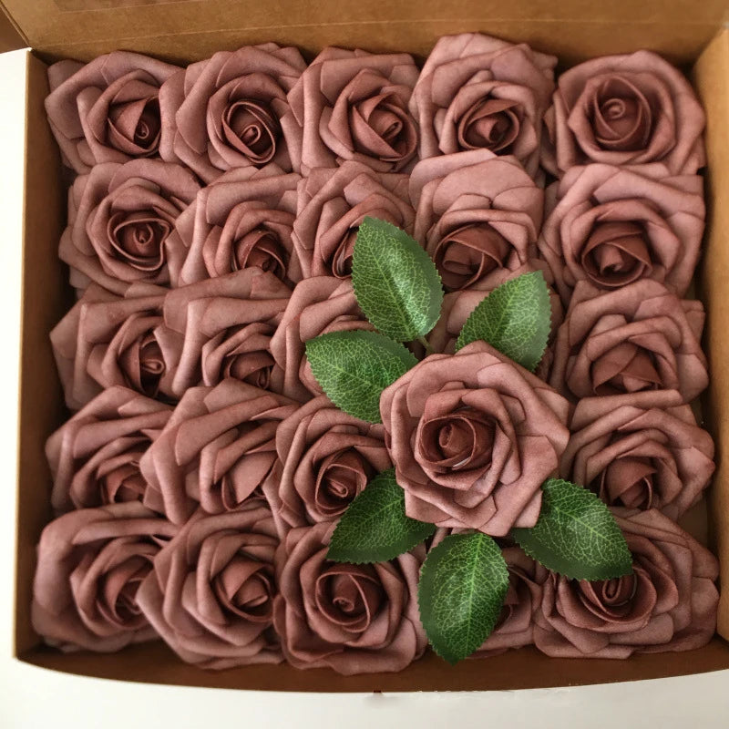 A box filled with artificial real touch foam roses in various shades of dusty rose and mauve.