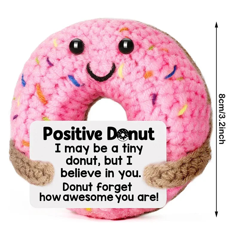 Pink donut crochet doll with a positive message card that says I may be a tiny donut but I believe in you.