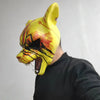A yellow latex mask shaped like a tiger's head with blood splatter details, worn by a person.