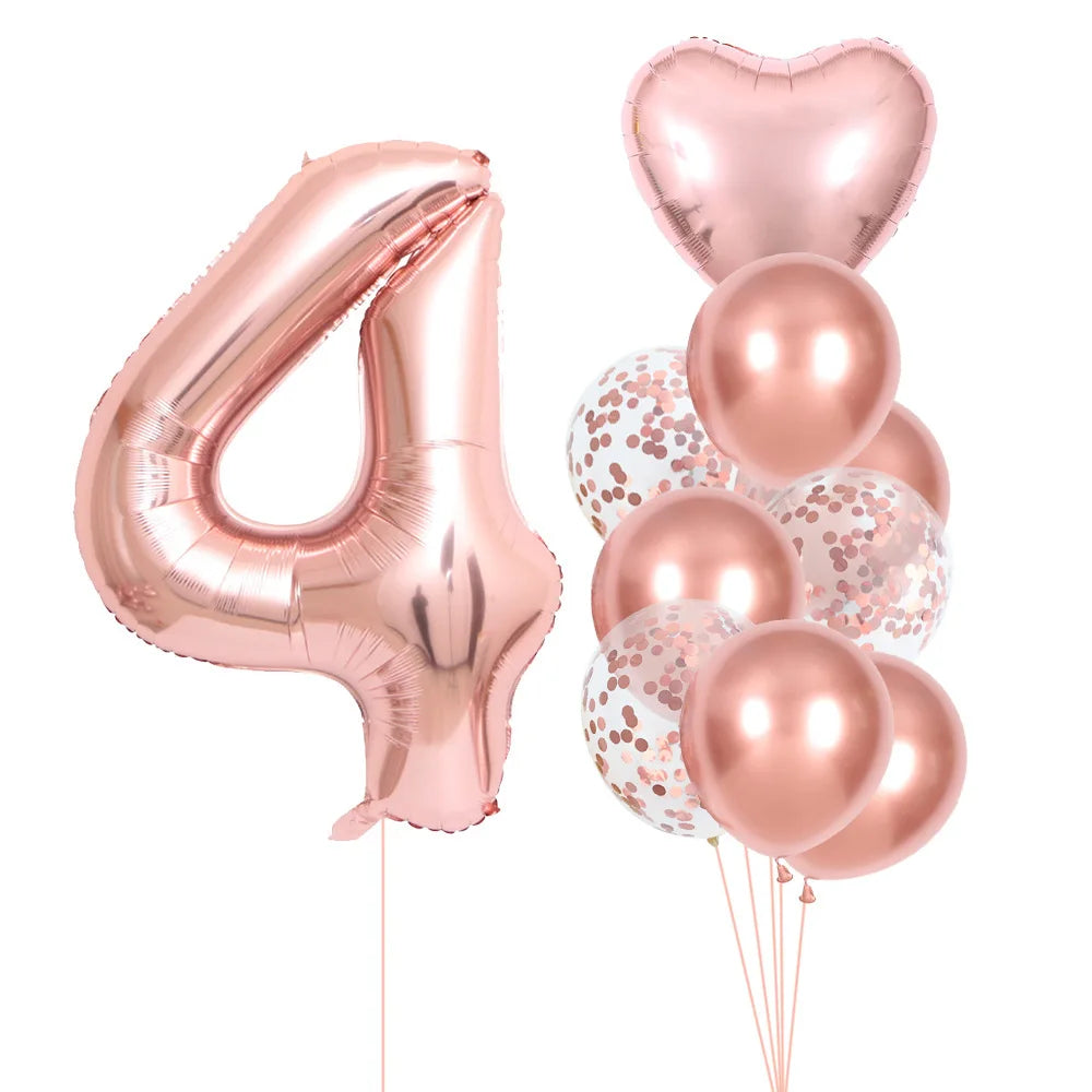 A set of rose gold foil balloons shaped like the number four and several heart-shaped balloons for party decor