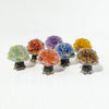 A collection of natural crystal mushroom trees displaying various colors including green, orange, purple, blue, and yellow.