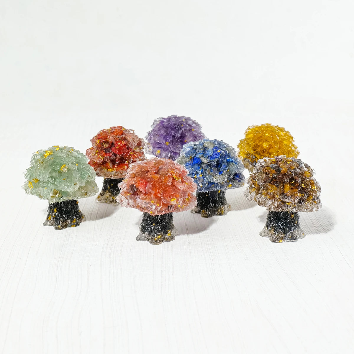 A collection of natural crystal mushroom trees displaying various colors including green, orange, purple, blue, and yellow.