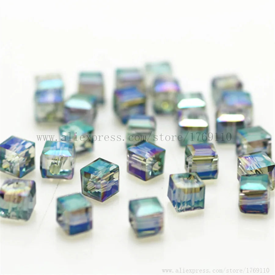 A collection of square cut glass crystal beads in various shades of blue and purple for jewelry making