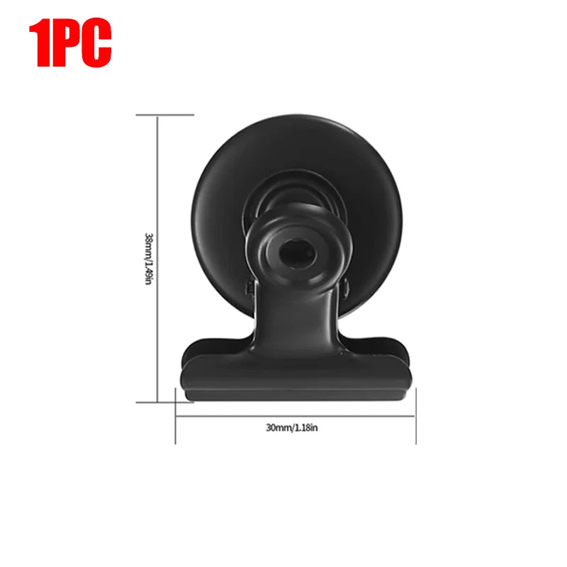 A black heavy duty fridge magnetic clip with a round base and a flat mounting section.