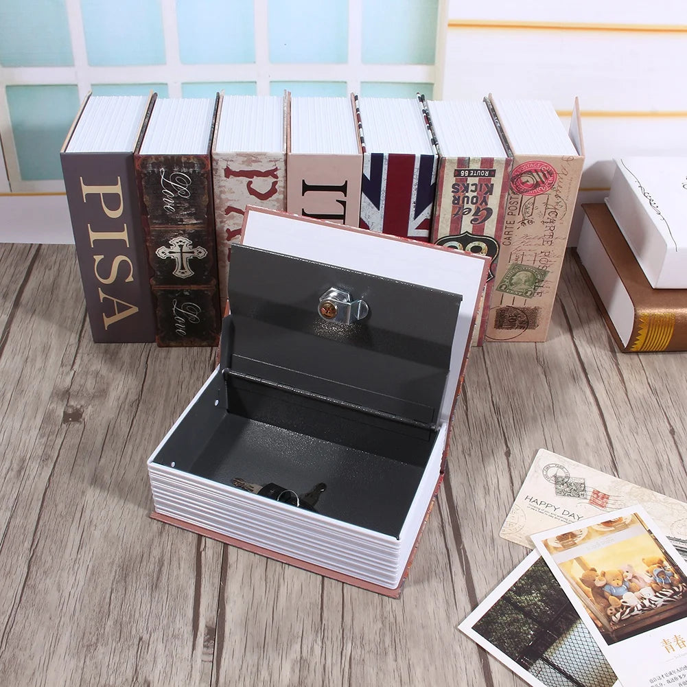 A black lock box with a clear glass window is displayed in an open wooden box surrounded by books.