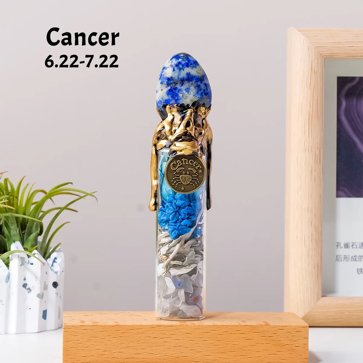 A natural crystal zodiac wishing bottle featuring blue and gold stones, displayed on a wooden surface.