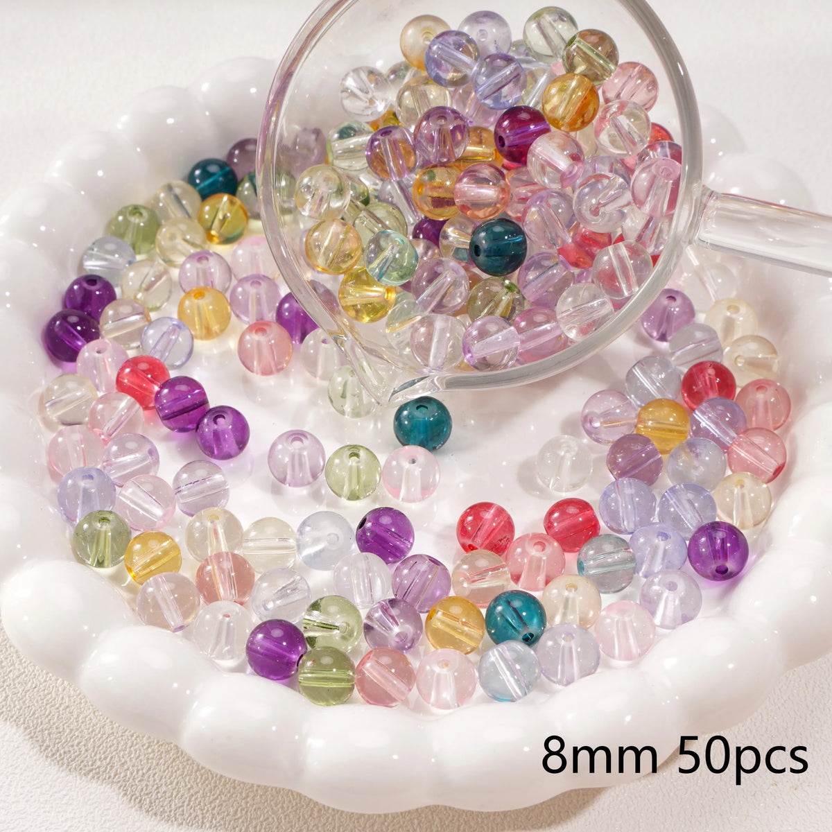 A clear glass bowl filled with colorful round spacer beads for jewelry making
