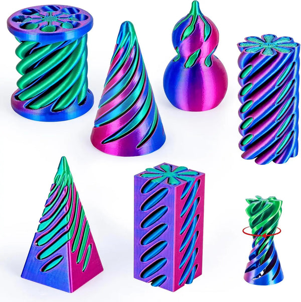 A set of 3D printed spiral fidget toys in various shades of blue, green, and magenta.
