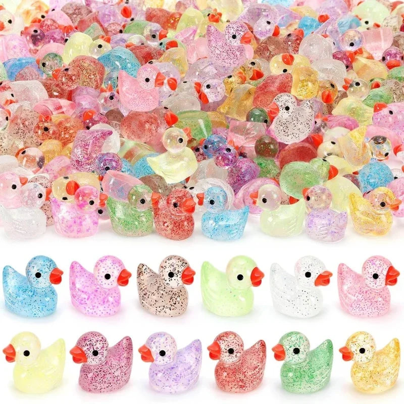 A collection of glow-in-the-dark duck figurines in various colors and finishes.