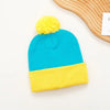 A bright blue knitted beanie with a yellow pom-pom and matching yellow knitted gloves.