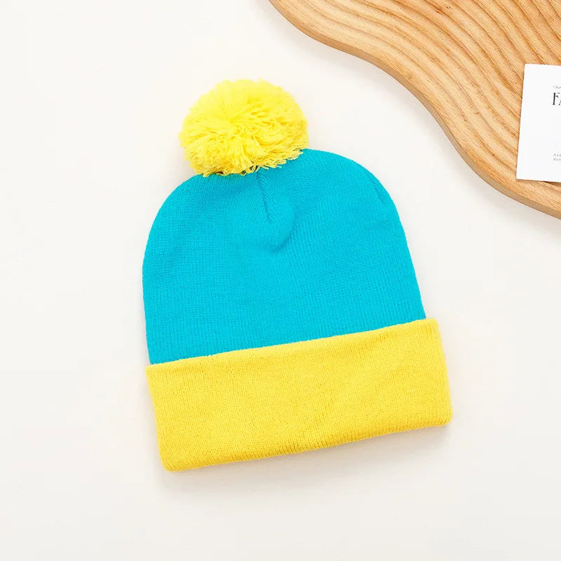 A bright blue knitted beanie with a yellow pom-pom and matching yellow knitted gloves.