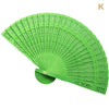 A bright green hand carved bamboo folding fan shown open and angled.