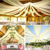 Elegant wedding decor featuring sheer chiffon curtains and floral arrangements under a wooden ceiling.