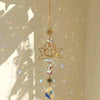 A hanging golden chain features a lotus flower crystal glass suncatcher with prism beads.