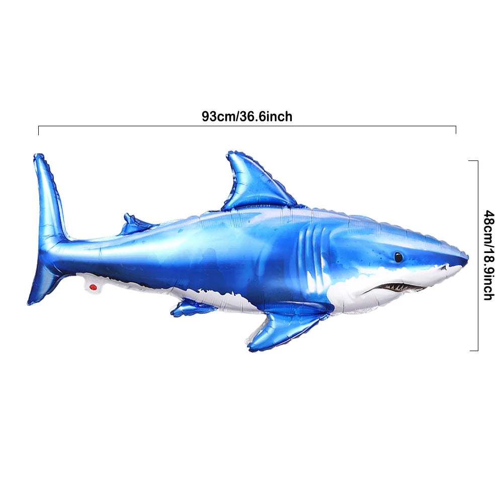 Blue shark foil balloon with fins and mouth, used for ocean-themed party decorations.