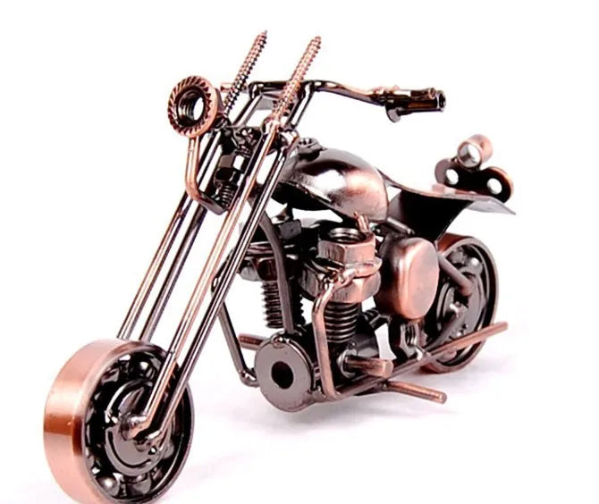 A handcrafted metal motorcycle model with a vintage finish and detailed engine components.