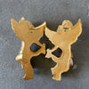 A pair of gold-colored wall decor featuring stylized cherub or angel figures.