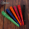 A collection of hand carved bamboo folding fans in various colors including green, blue, orange, and red.