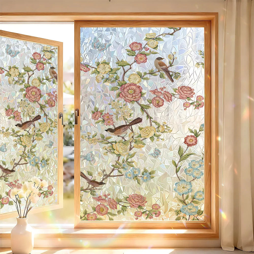 A close-up view of a decorative privacy window film featuring floral and leaf patterns on a wooden frame.