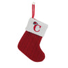 A red knitted sock with a white cuff featuring a red letter C and a hanging loop.