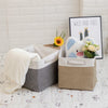 Four fabric storage cubes with metal frames in gray, beige, and white are displayed on a white surface.
