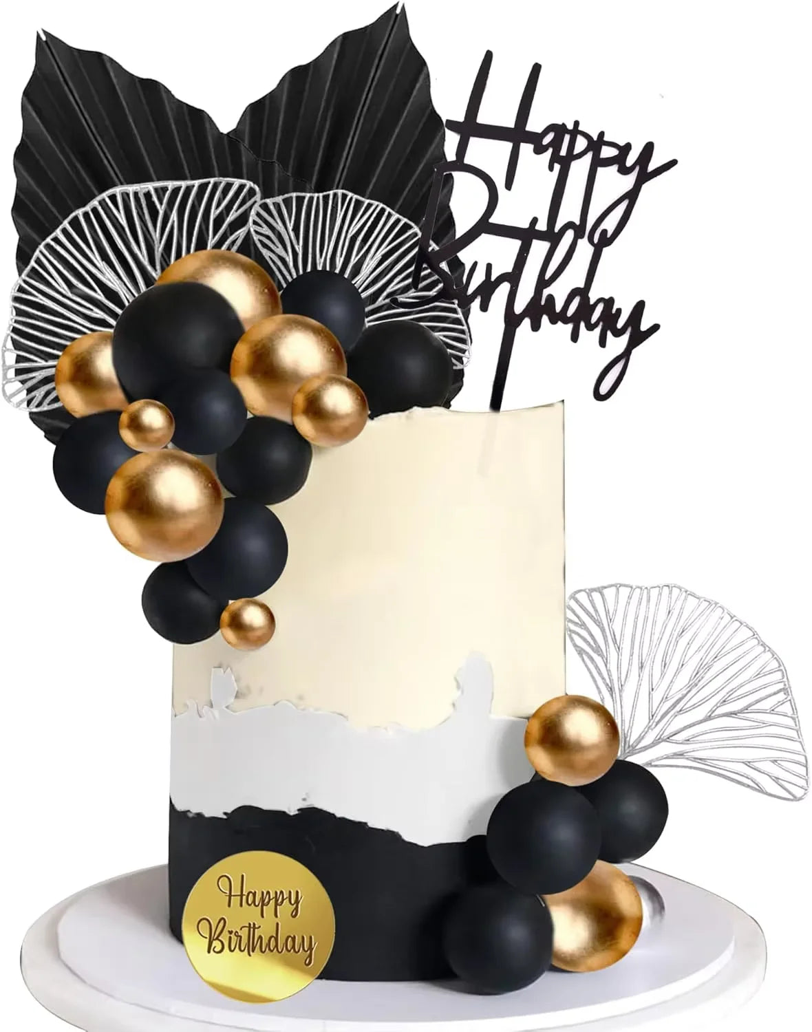 A white cake decorated with black and gold spherical toppers and a black fan-shaped topper for a birthday celebration.