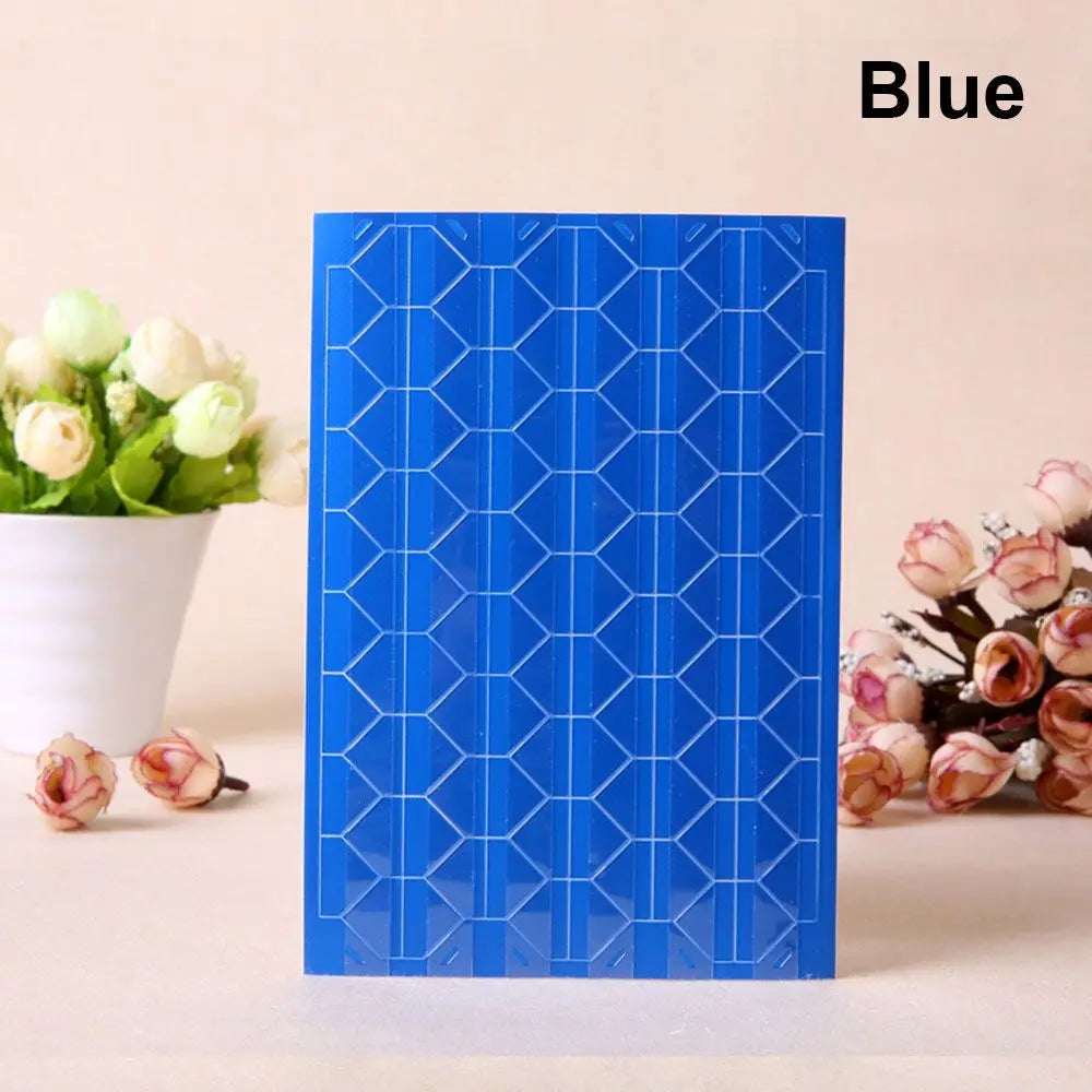 A vertical blue PVC photo corner protector with a geometric pattern, next to white flowers.
