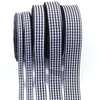 A roll of black and white gingham ribbon for gift wrapping, crafts, or party decor.