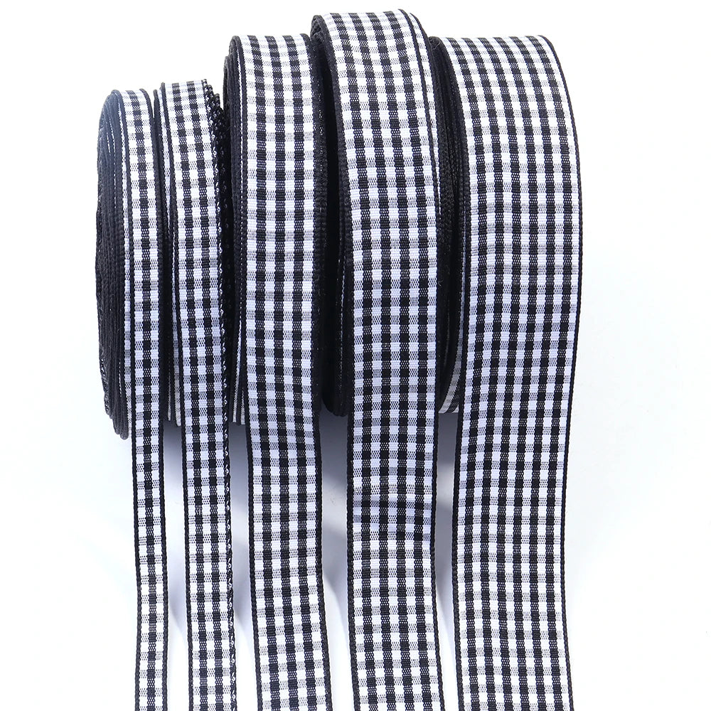 A roll of black and white gingham ribbon for gift wrapping, crafts, or party decor.