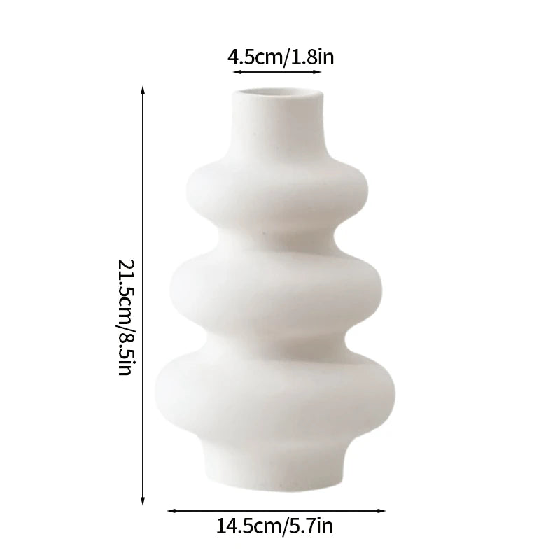 Modern white plastic decorative vase with stacked, rounded shapes.