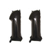 Two black helium foil number balloons shaped like the number 1.