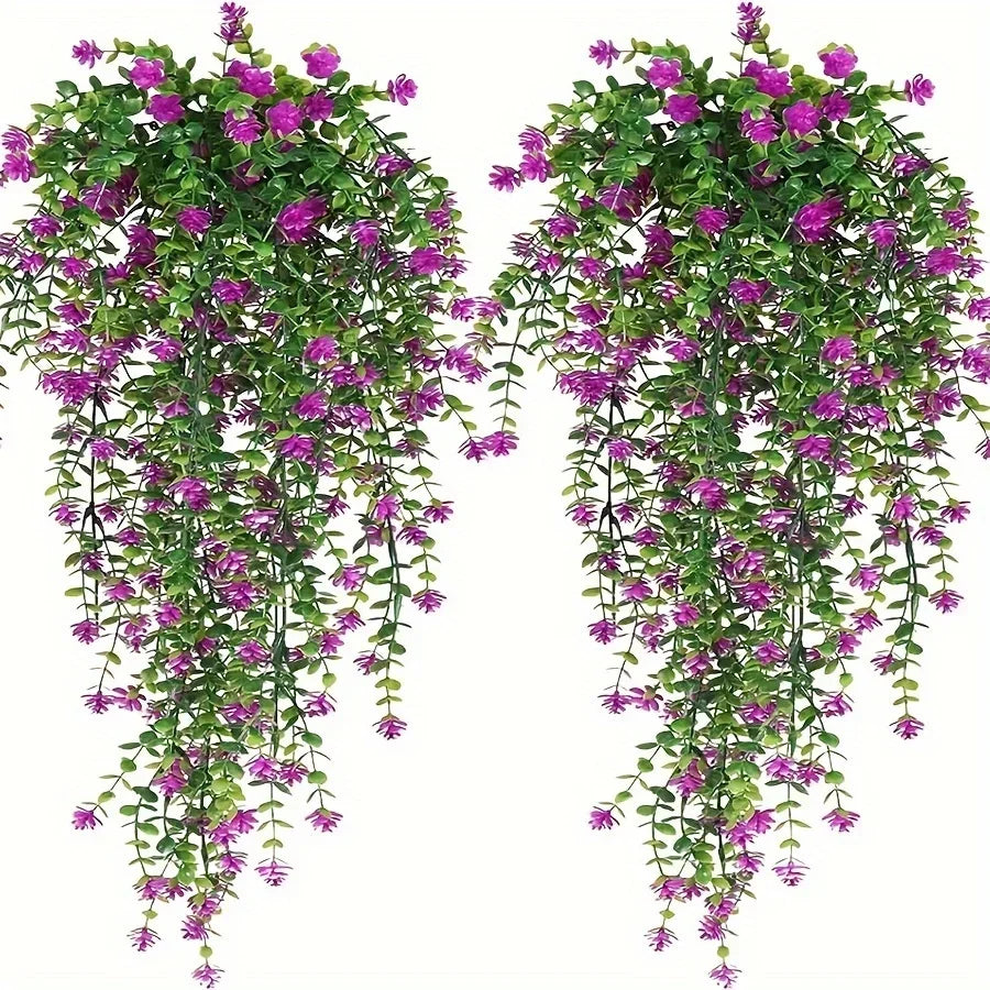 A set of three lifelike faux eucalyptus hanging plants with vibrant green leaves and purple flowers.