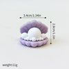 A set of three pastel purple ocean animal cake toppers, including a whale, octopus, and turtle.