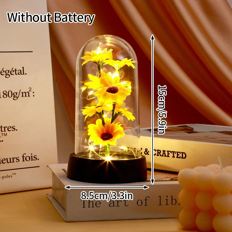 A glass dome lamp featuring a yellow flower, illuminated without a battery.