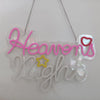 A clear acrylic neon sign shaped like the word Heaven's Night with pink and yellow lettering.