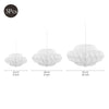 A set of three white 3D cloud paper honeycomb ball decorations in different sizes.