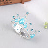 Silver tiara crown accessory with light blue gemstones and pearl accents